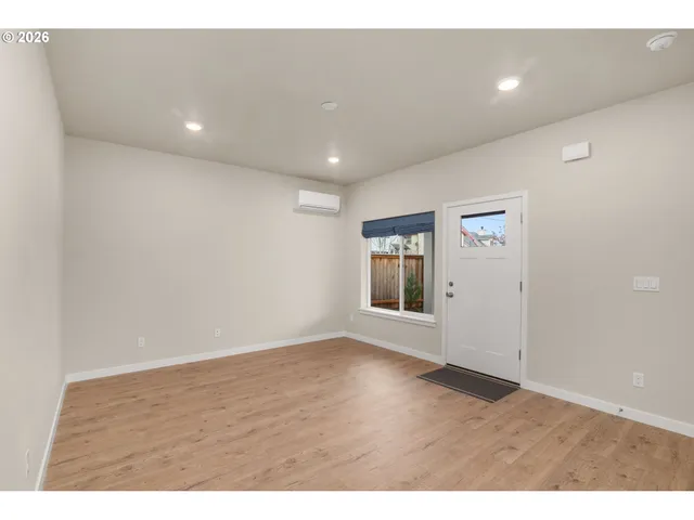 a view of an empty room with wooden floor