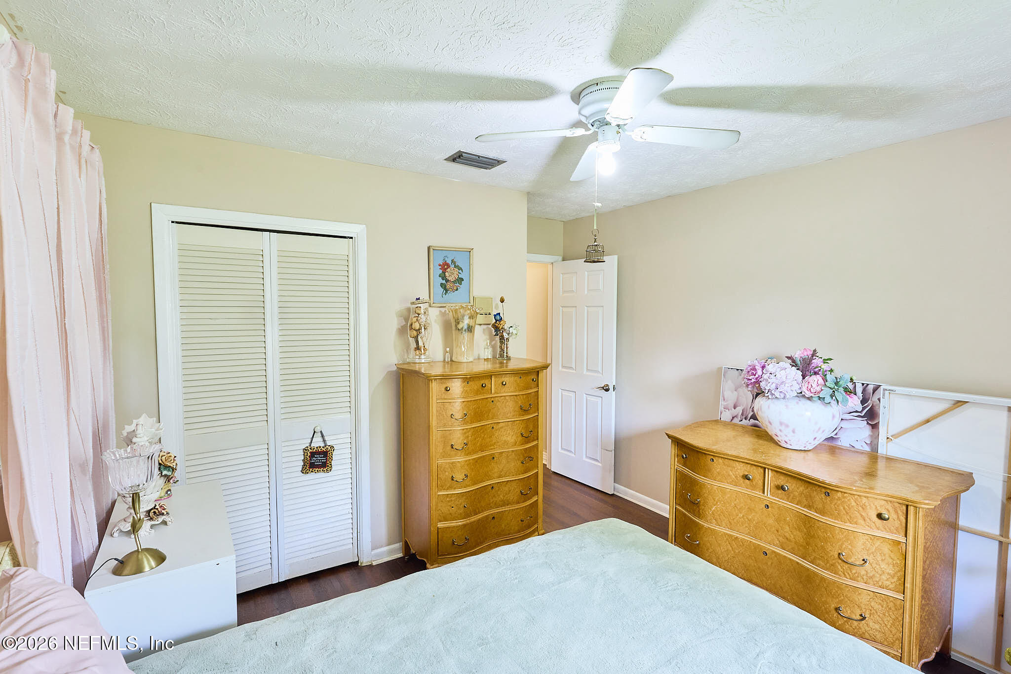8965 San Rae Road Jacksonville, FL 32257 - Photo 13 of 46 a bedroom with a bed and a chandelier