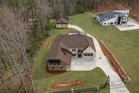 a aerial view of a house with swimming pool and deck
