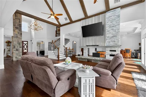 a kitchen with stainless steel appliances granite countertop a sink a stove and a wooden floors