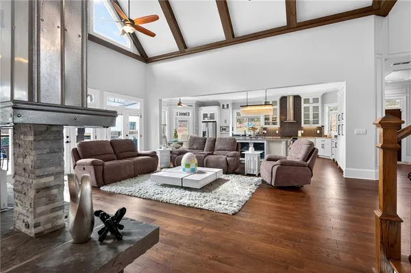 a kitchen with stainless steel appliances granite countertop a sink a stove and a wooden floors