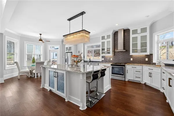 a kitchen with a sink cabinets and wooden floor