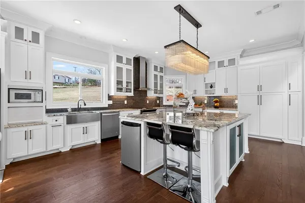 a kitchen with counter top space and wooden floor