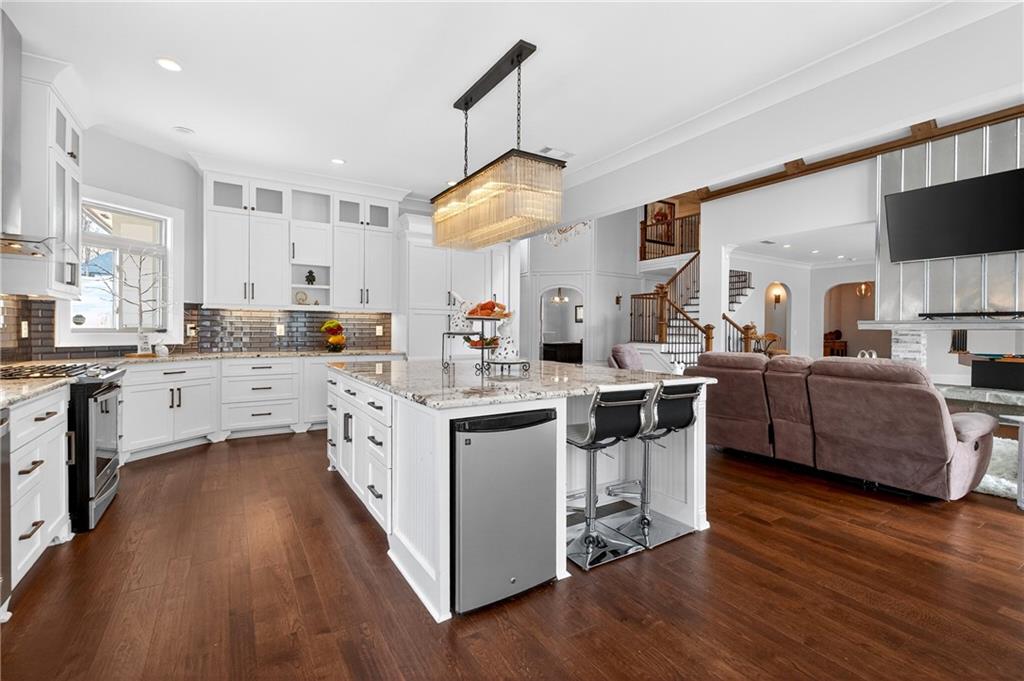 3944 Hamilton Mill Road Buford, GA 30519 - Photo 16 of 55 a kitchen with a sink cabinets and wooden floor