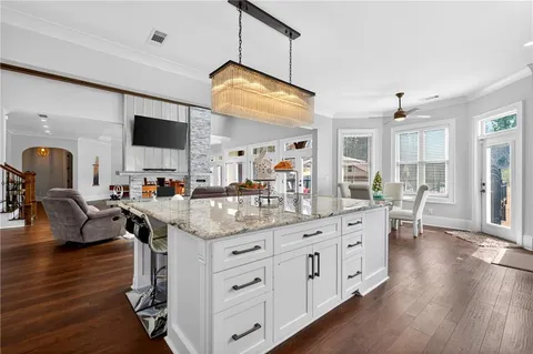 a living room with furniture and kitchen view
