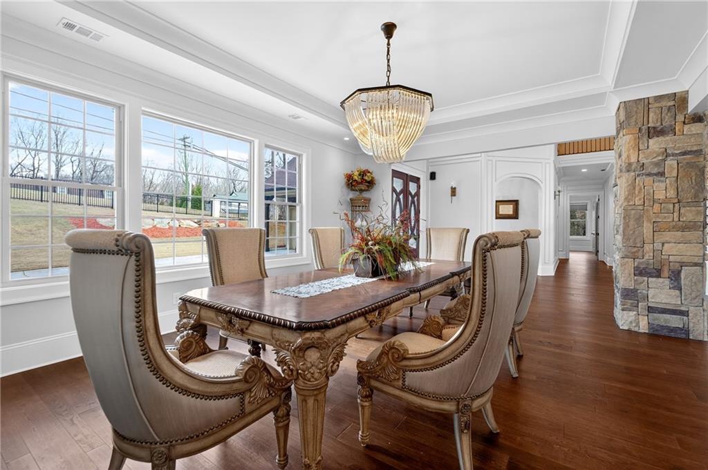 3944 Hamilton Mill Road Buford, GA 30519 - Photo 20 of 55 a view of a dining room with furniture wooden floor and chandelier