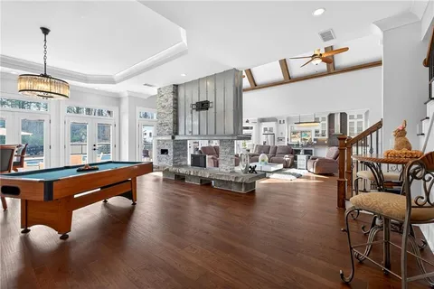 a room with a table chairs and wooden floor
