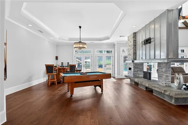a room with a table chairs and wooden floor