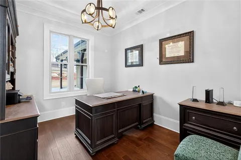 a bedroom with furniture and a large window