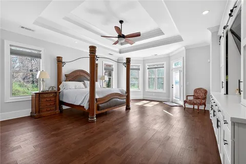 a spacious bathroom with double vanity a large mirror a vanity a window and a bathtub