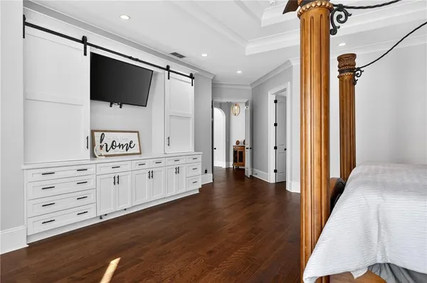 a spacious bathroom with double vanity a large mirror a vanity a window and a bathtub