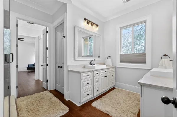 a bathroom with a tub shower and mirror