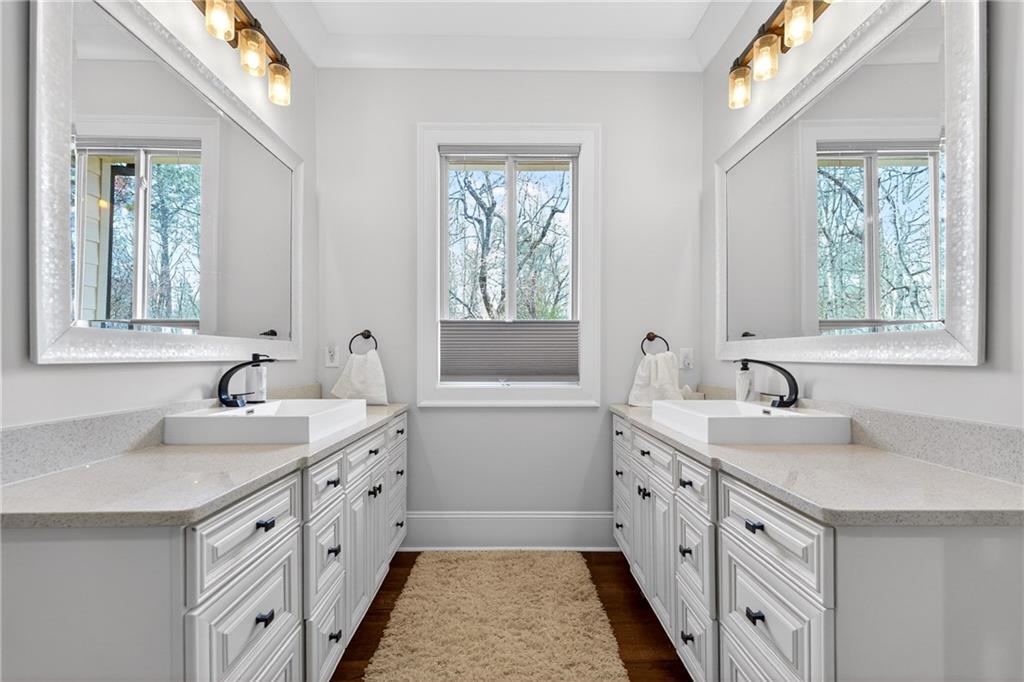 3944 Hamilton Mill Road Buford, GA 30519 - Photo 33 of 55 a spacious bathroom with double vanity a large mirror a vanity a window and a bathtub