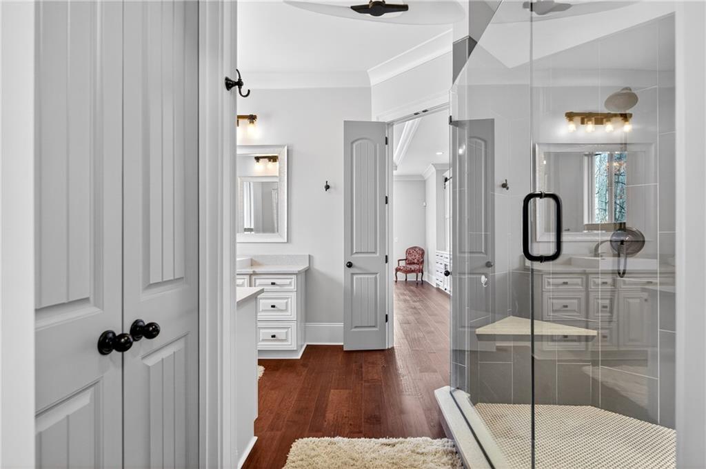 3944 Hamilton Mill Road Buford, GA 30519 - Photo 35 of 55 a bathroom with a tub shower and mirror