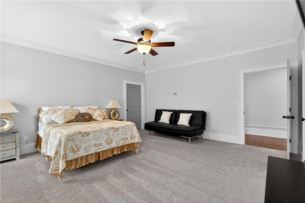 3944 Hamilton Mill Road Buford, GA 30519 - Photo 41 of 55 a bedroom with a bed and a chandelier