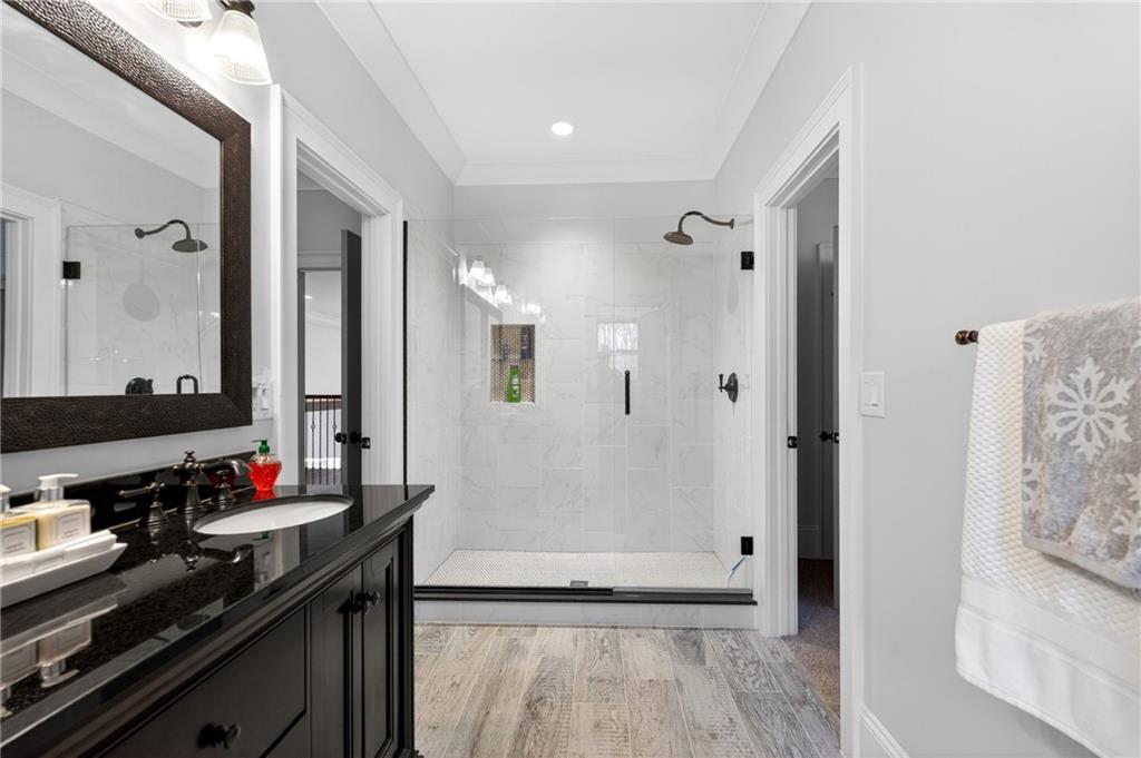 3944 Hamilton Mill Road Buford, GA 30519 - Photo 43 of 55 a bathroom with a mirror and a shower