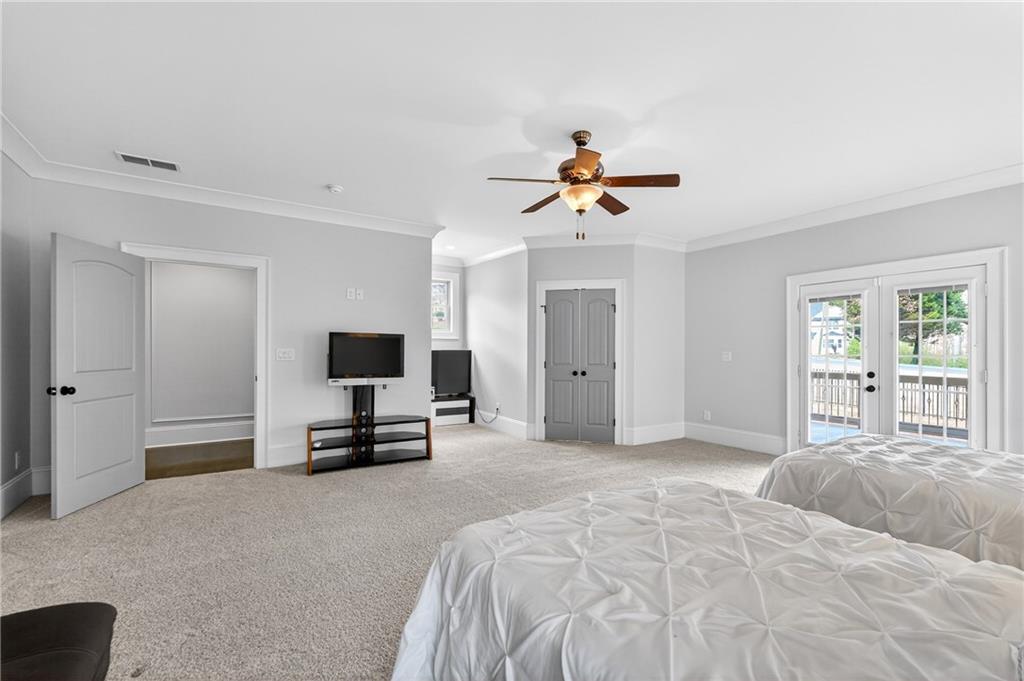 3944 Hamilton Mill Road Buford, GA 30519 - Photo 45 of 55 a bedroom with a bed and a flat screen tv