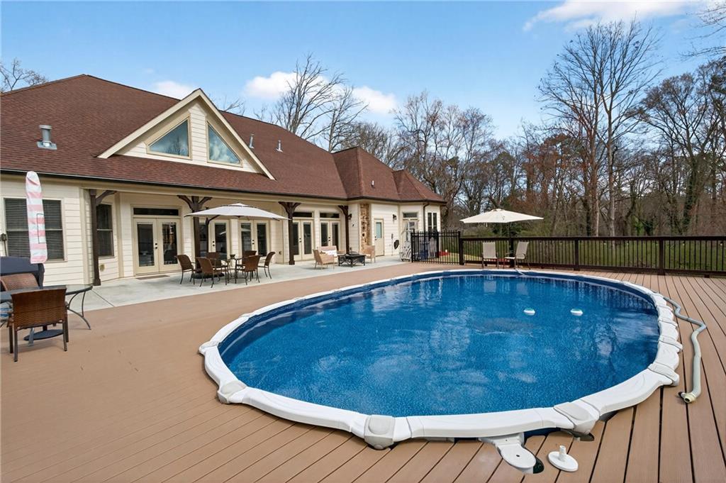 3944 Hamilton Mill Road Buford, GA 30519 - Photo 49 of 55 a view of a house with swimming pool and sitting area