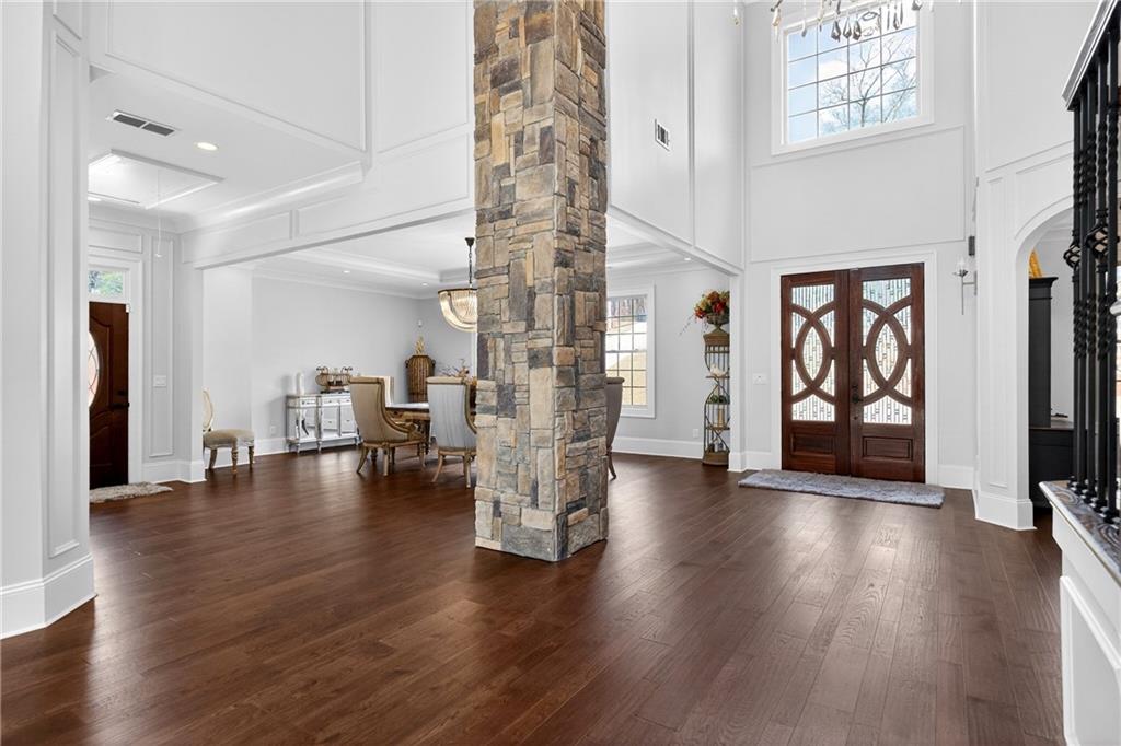 3944 Hamilton Mill Road Buford, GA 30519 - Photo 6 of 55 a view of empty room with wooden floor and windows