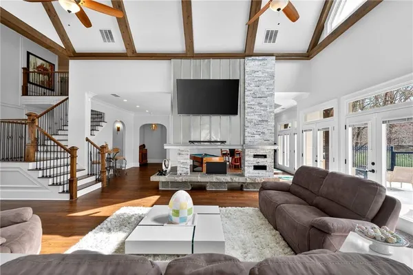 a kitchen with stainless steel appliances granite countertop a stove cabinets and wooden floor
