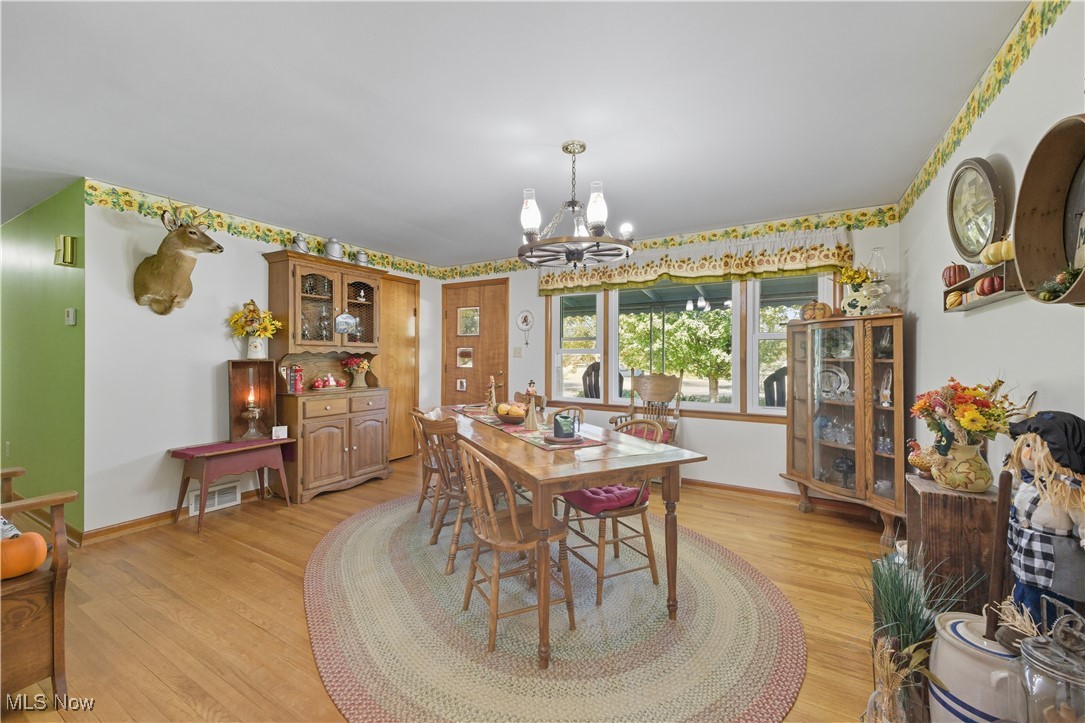 31085 Georgetown Road Salem, OH 44460 - Photo 10 of 50 Dining space with light wood-style flooring and a chandelier