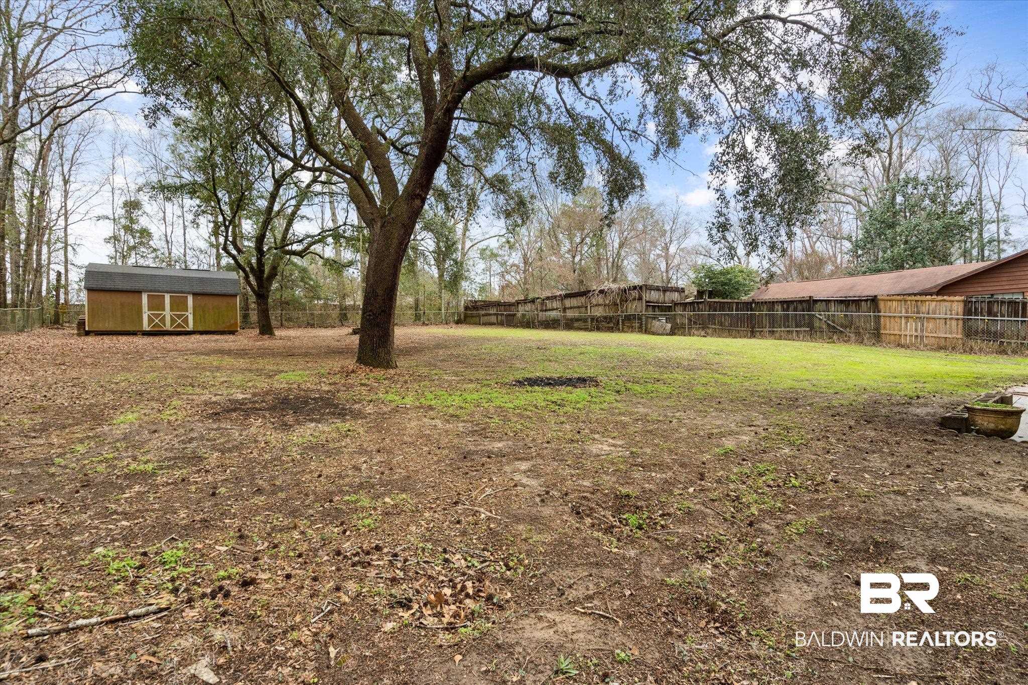 3541 Winston Drive Semmes, AL 36575 - Photo 15 of 20 View of yard featuring a storage shed, an outbuilding, and a fenced backyard