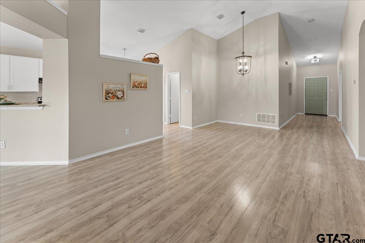 205 Freedom Trail Forney, TX 75126 - Photo 11 of 41 wooden floor in an empty room with a window