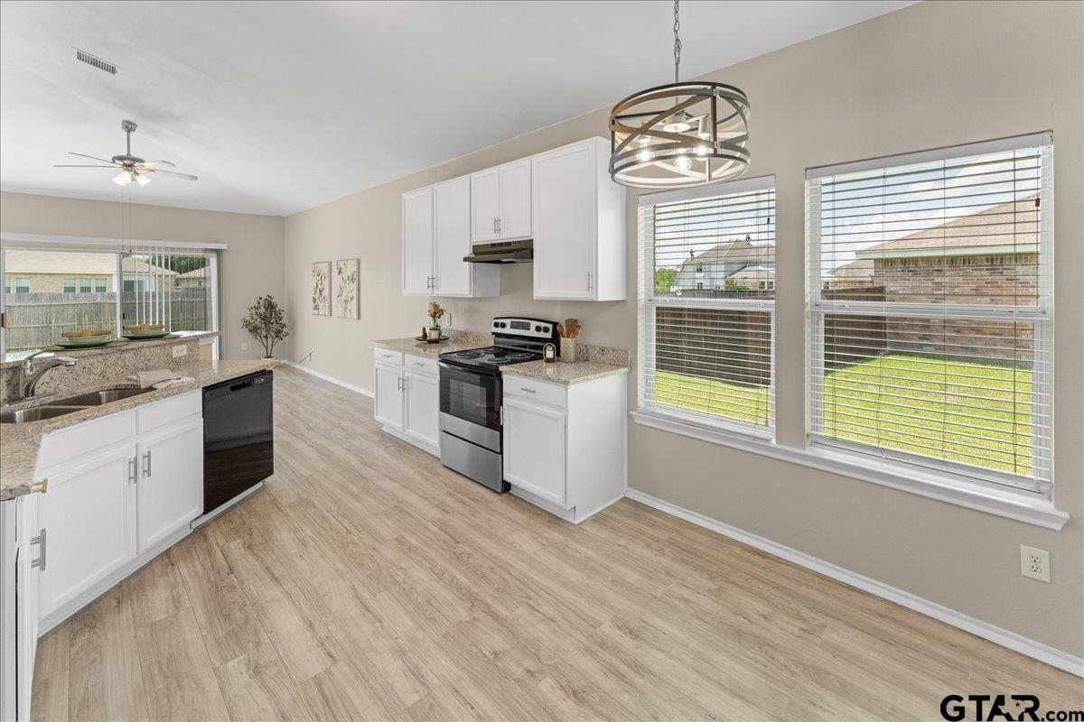 205 Freedom Trail Forney, TX 75126 - Photo 14 of 41 a kitchen with stainless steel appliances granite countertop a stove a sink and a granite counter tops with white cabinets