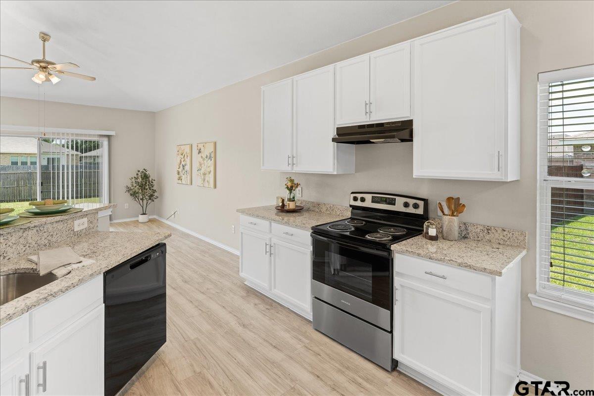 205 Freedom Trail Forney, TX 75126 - Photo 19 of 41 a kitchen with granite countertop a sink and a stove top oven