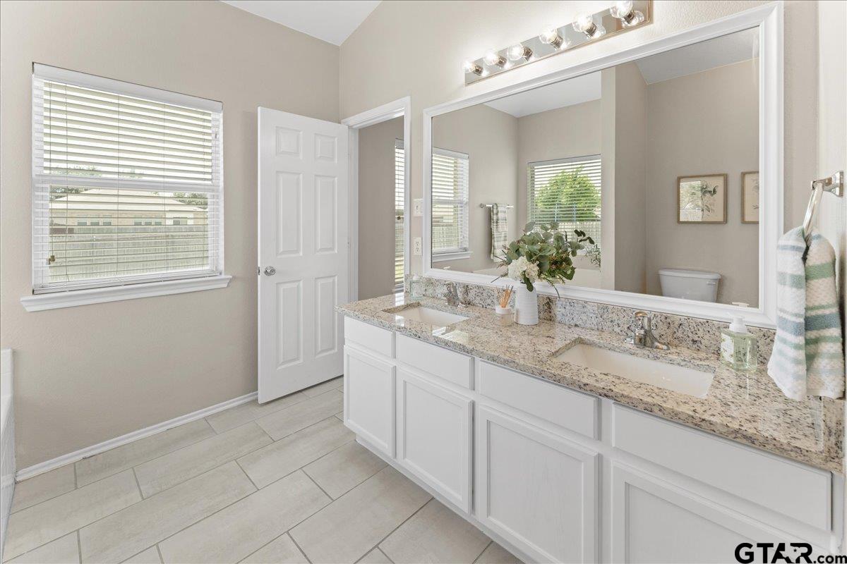 205 Freedom Trail Forney, TX 75126 - Photo 26 of 41 a bathroom with a granite countertop sink and a mirror