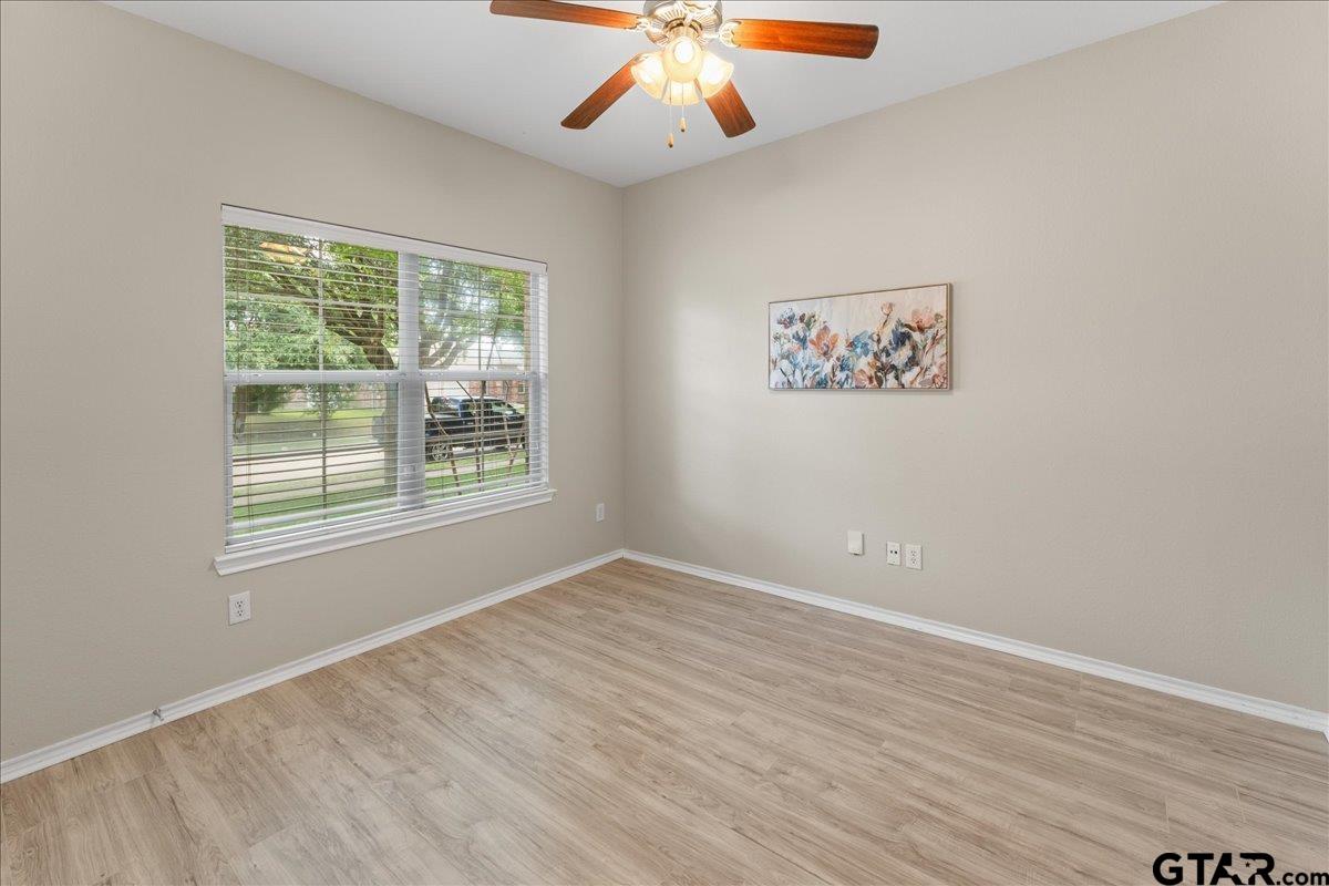 205 Freedom Trail Forney, TX 75126 - Photo 30 of 41 an empty room with a window and a ceiling fan