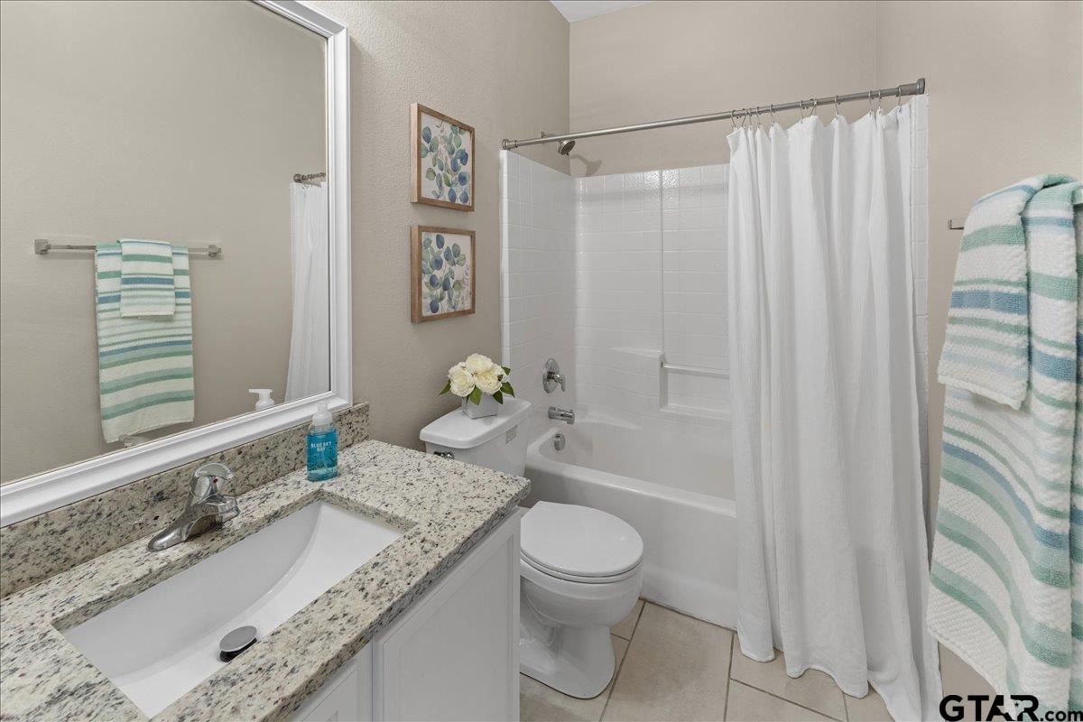 205 Freedom Trail Forney, TX 75126 - Photo 31 of 41 a bathroom with a granite countertop sink a toilet and shower