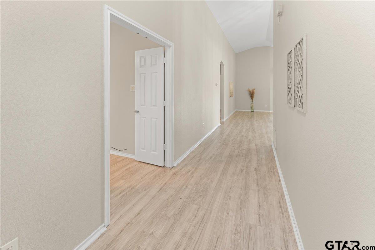 205 Freedom Trail Forney, TX 75126 - Photo 5 of 41 a view of a hallway with wooden floor and closet