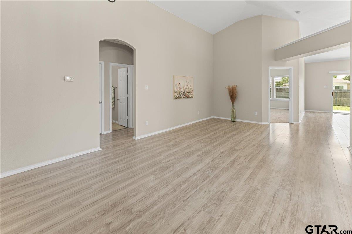205 Freedom Trail Forney, TX 75126 - Photo 6 of 41 an empty room with wooden floor and windows