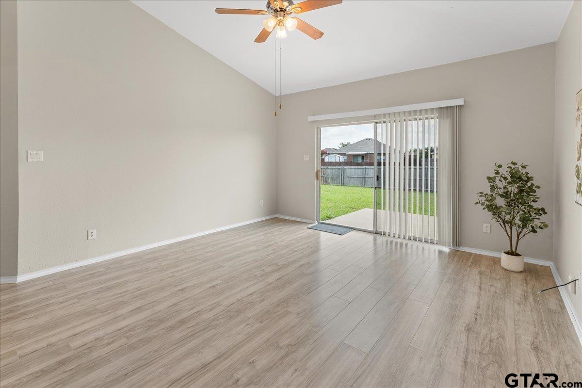 205 Freedom Trail Forney, TX 75126 - Photo 8 of 41 a view of an empty room with wooden floor and a window