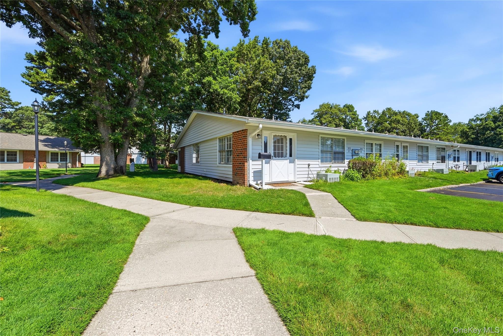 232 Blackpool Court, Unit F Ridge, NY 11961 - Photo 2 of 24 Rear Entrance and parking spot