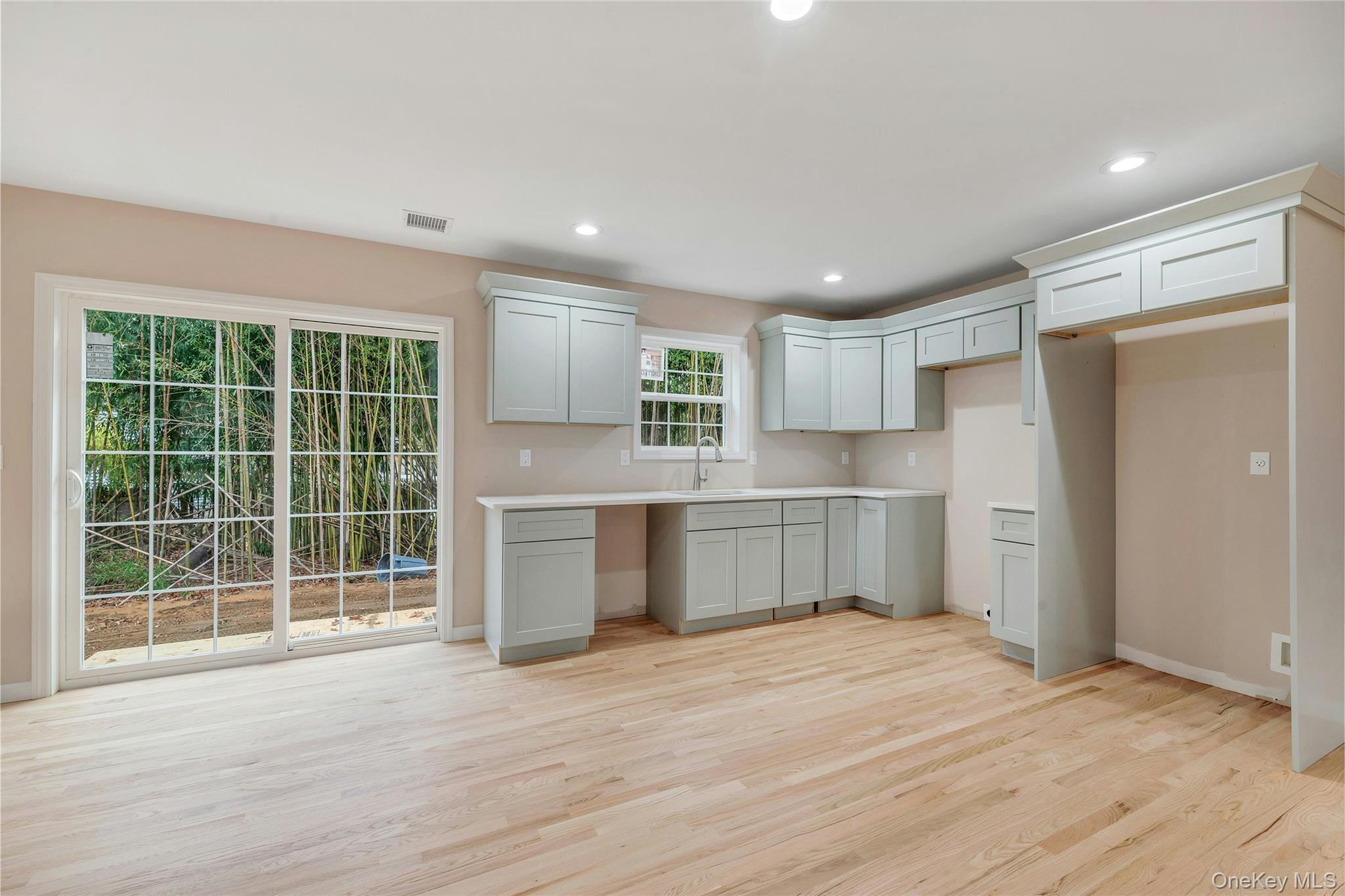 487 Neighborhood Road Shirley, NY 11967 - Photo 4 of 20 a kitchen with a refrigerator and window