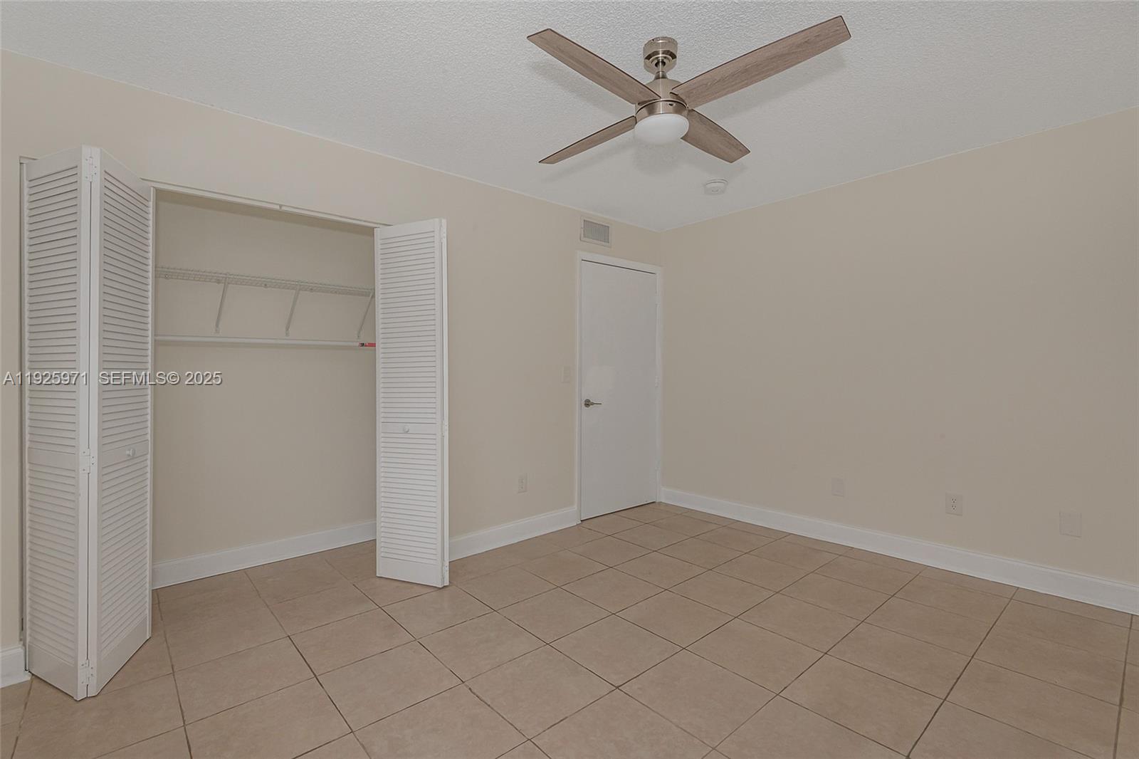 Hialeah Hialeah, FL 33012 - Photo 19 of 27 an empty room with closet and fan