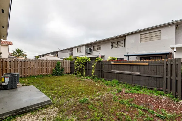 a backyard of a house with wooden fence