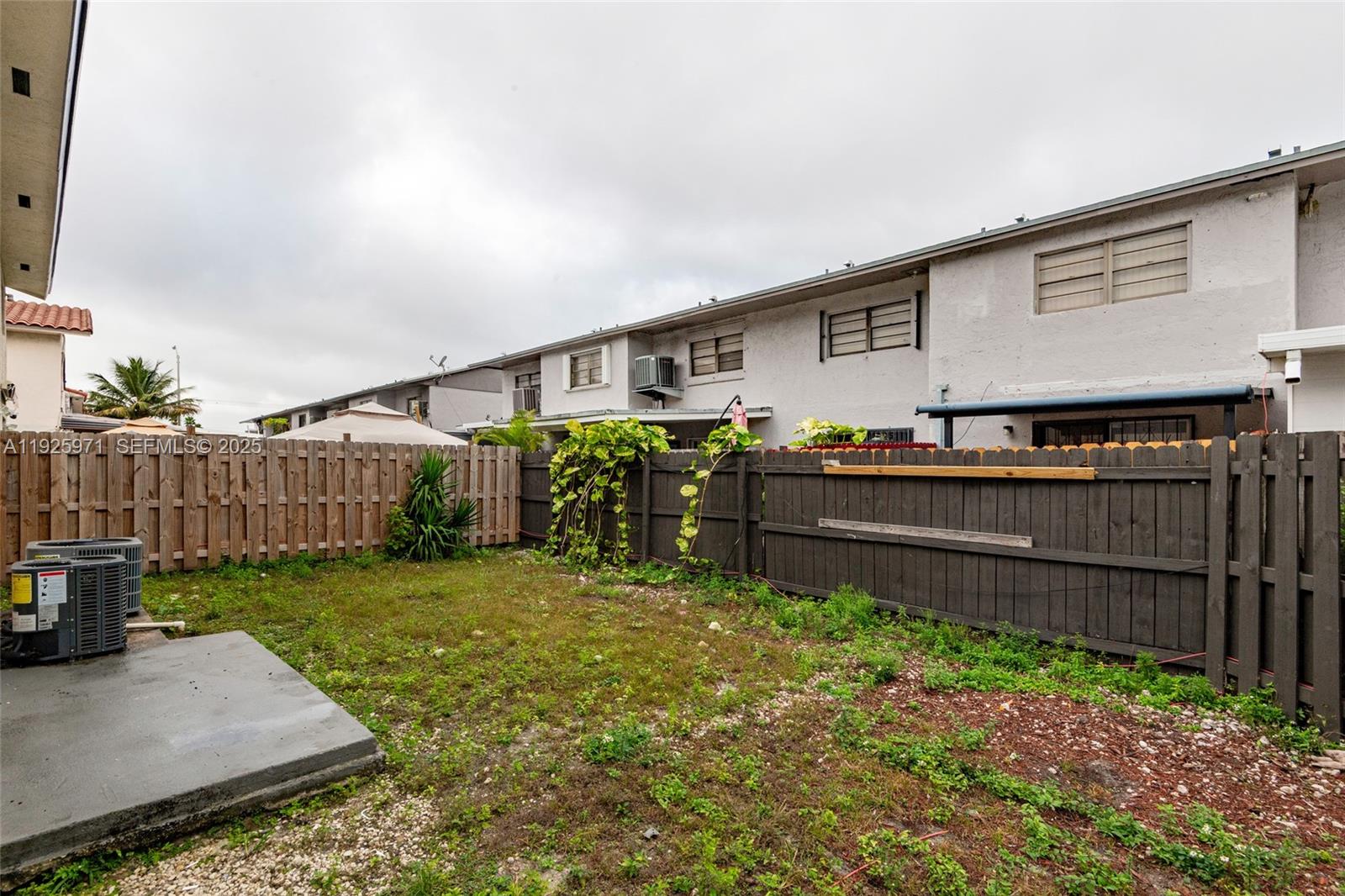 Hialeah Hialeah, FL 33012 - Photo 24 of 27 a backyard of a house with wooden fence