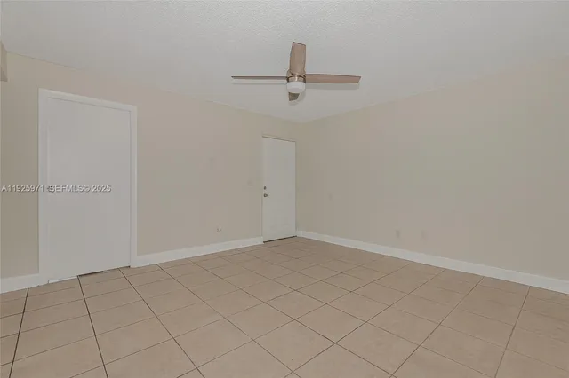 an empty room with a ceiling fan