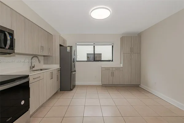 a kitchen with a sink a stove and refrigerator