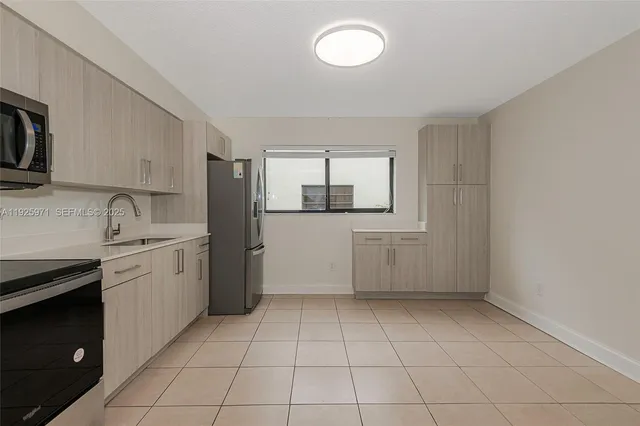 a kitchen with a sink a stove and refrigerator