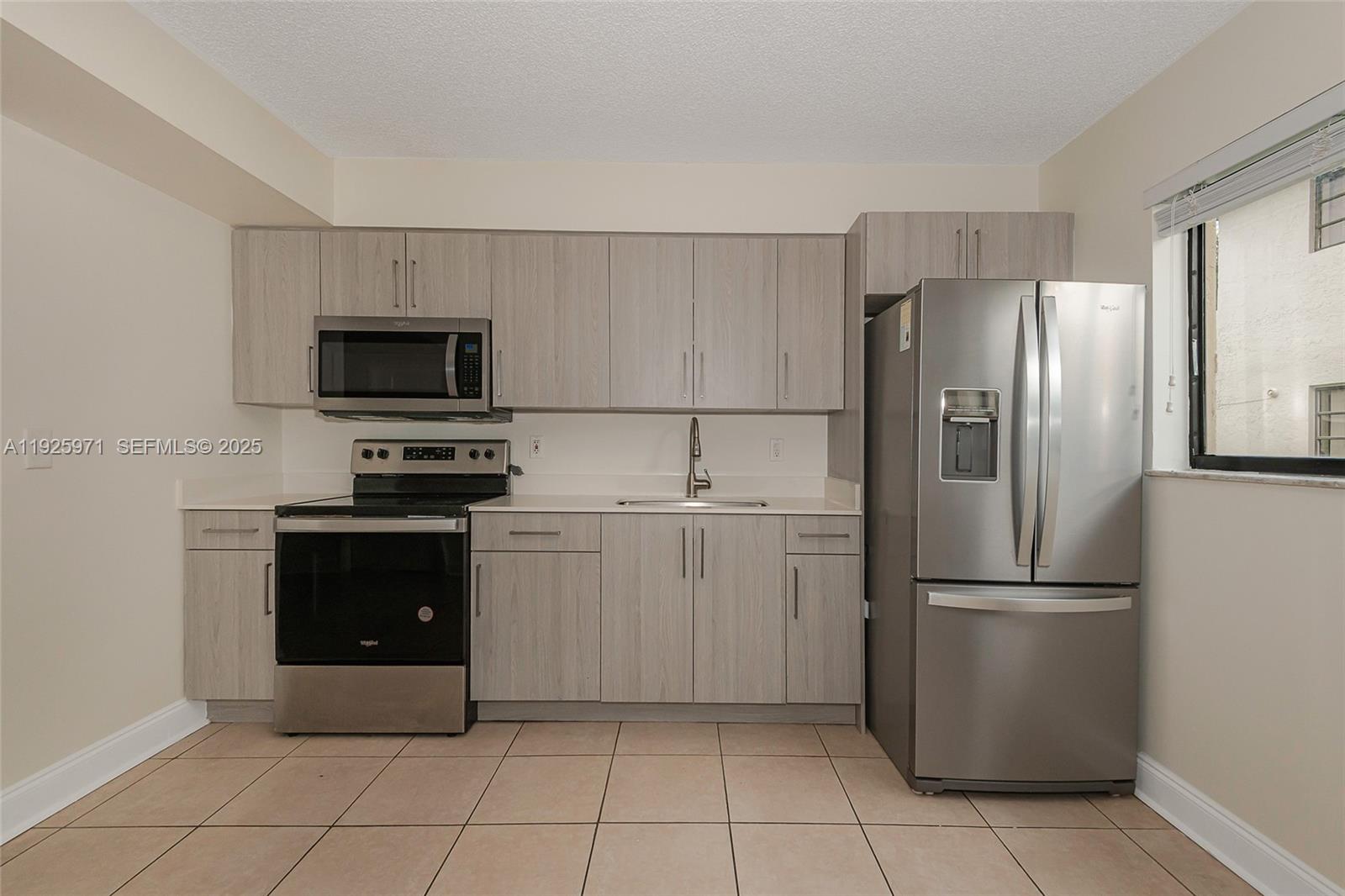 Hialeah Hialeah, FL 33012 - Photo 10 of 27 a kitchen with a refrigerator and a stove top oven