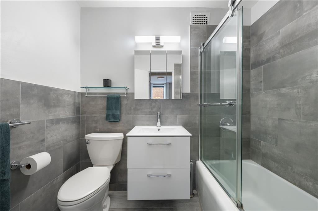 515 East 7th Street, Unit 3P Brooklyn, NY 11218 - Photo 7 of 14 a bathroom with a sink toilet and shower