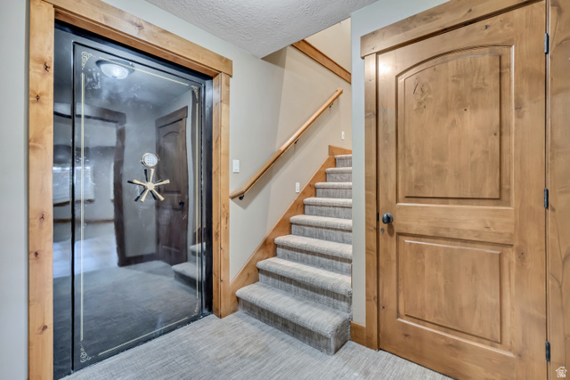 896 West 675 South Mapleton, UT 84664 - Photo 45 of 77 Foyer entrance with stairway, a textured ceiling, and carpet flooring