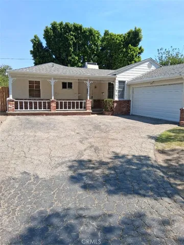 a front view of house with yard and trees around