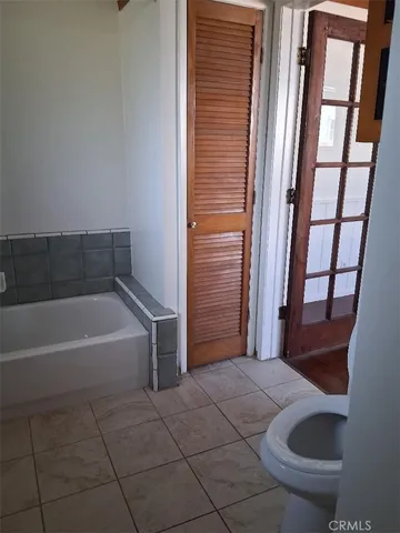 a bathroom with a bathtub and toilet