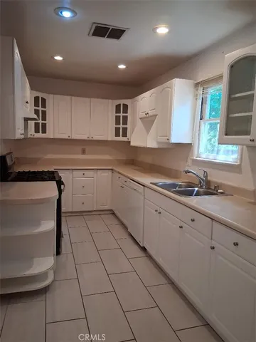 a kitchen with sink cabinets and window