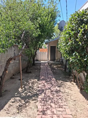 a view of a backyard with a tree